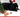 Rabbit sitting under a christmas tree with a hat, what christmas costume could my pet wear