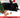 Rabbit sitting under a christmas tree with a hat, what christmas costume could my pet wear